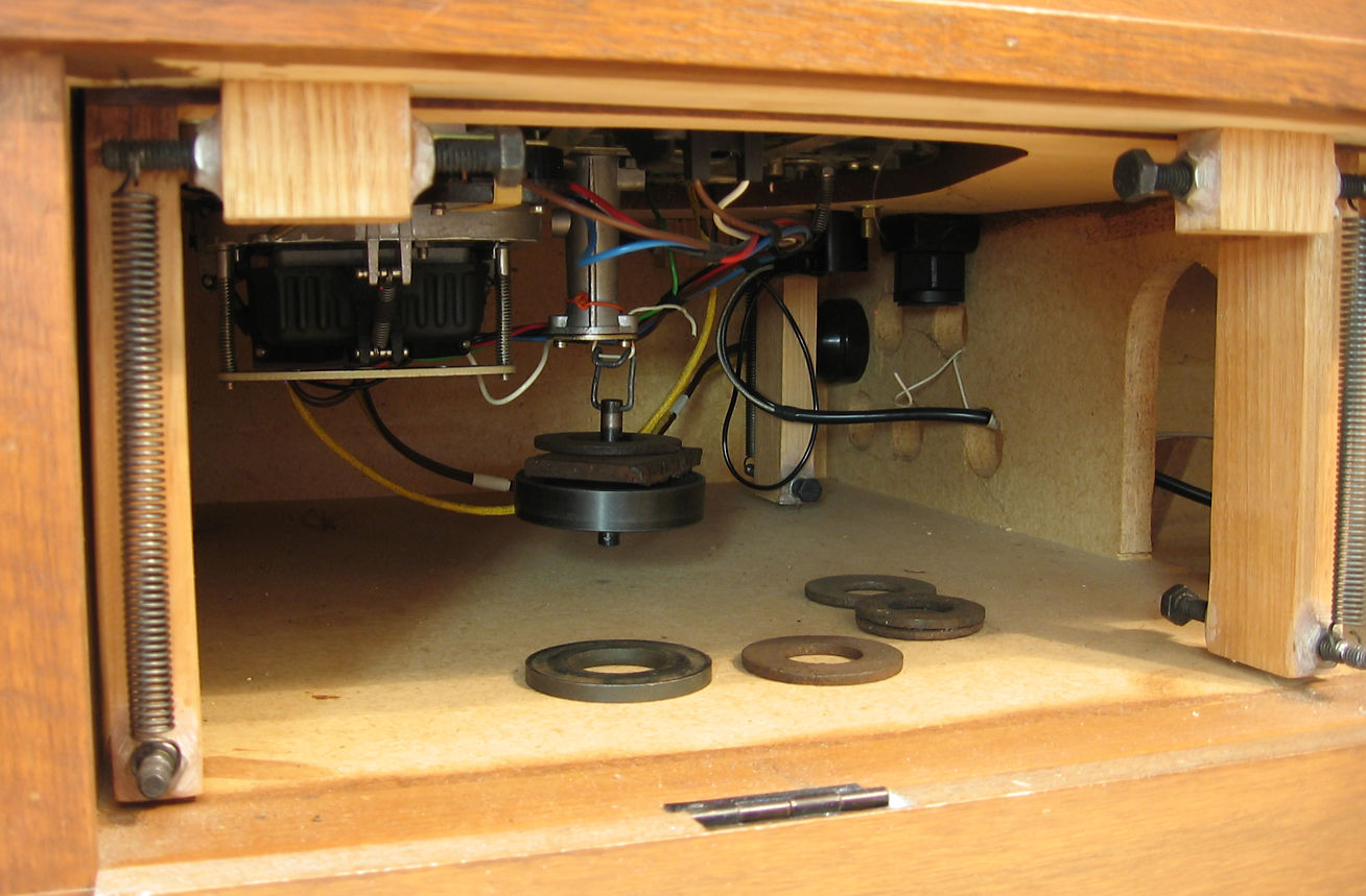 A view of the interior of the cabinet showing the spring suspension system for the plinth.